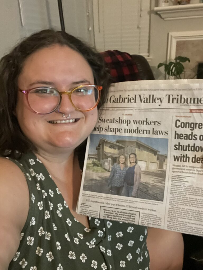 image of Victoria Ivie holding up newspaper